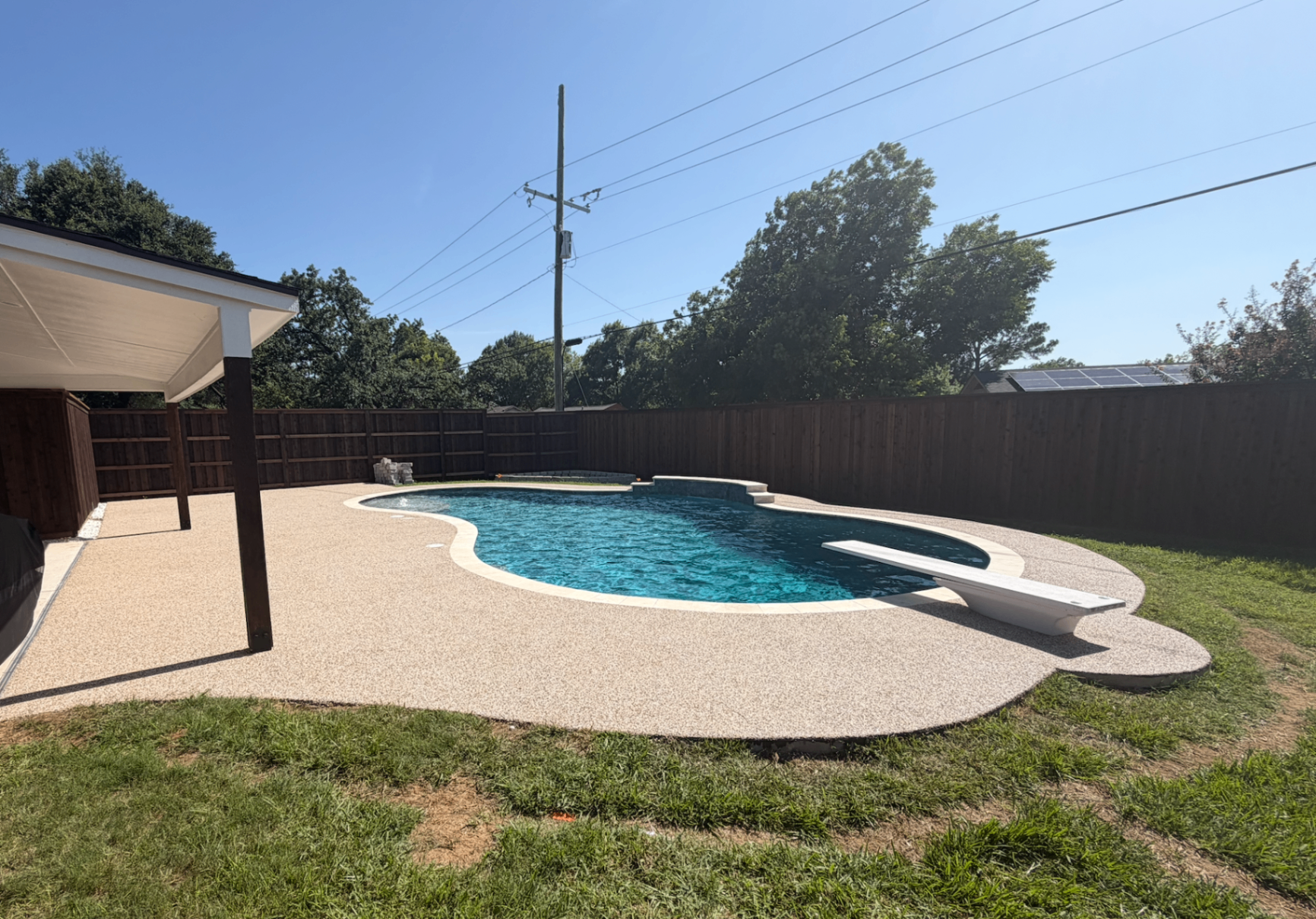Completed rubber surface around a pool with textured finish and clean edges